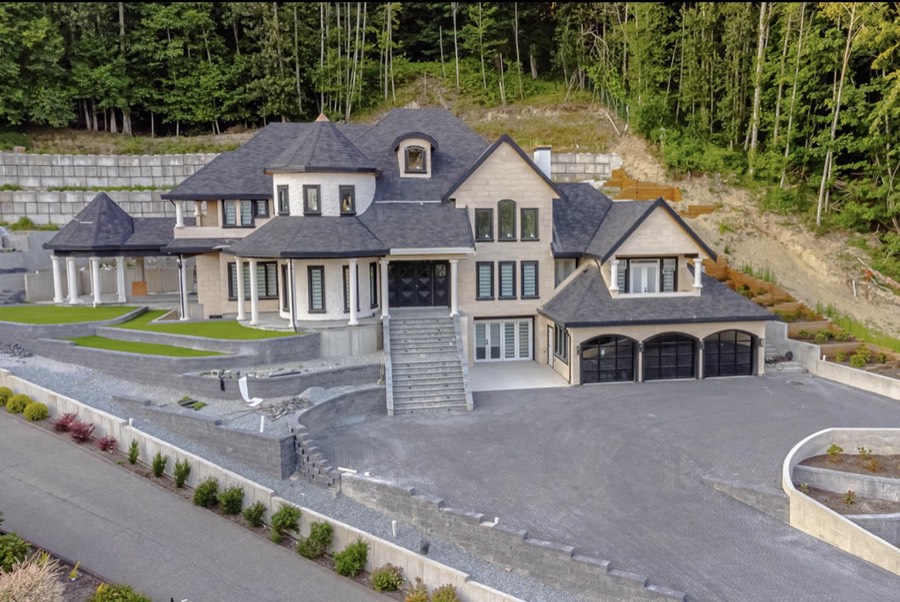 Large home with tiered block retaining walls and new landscaping