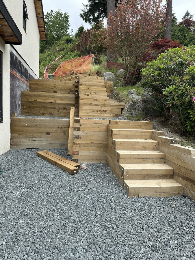 Timber retaining steps set into a gravel slope