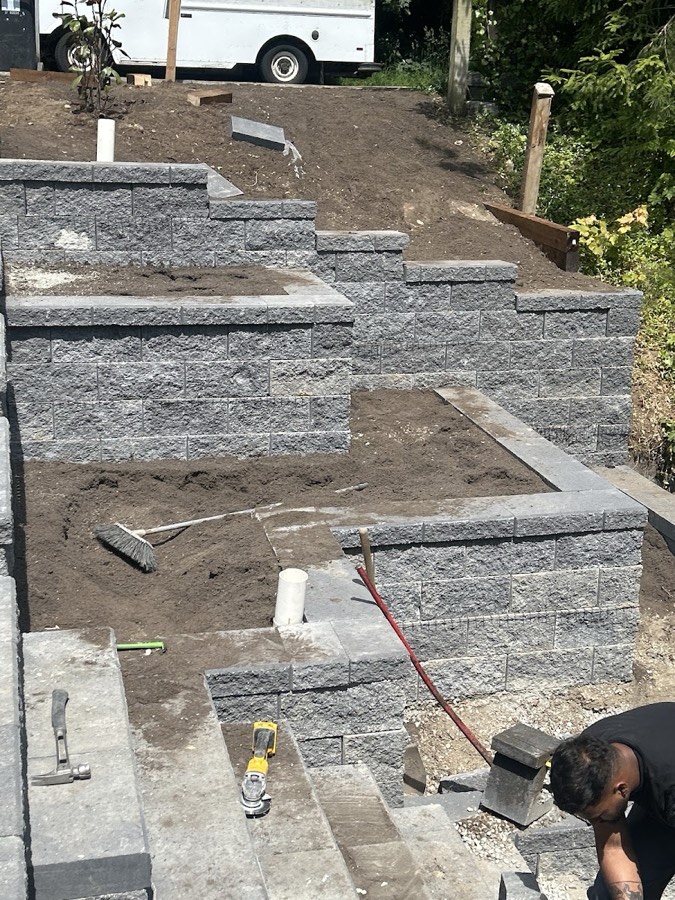 Stone steps and wall units part way through installation